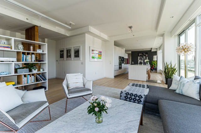 Spacious living room with modern furniture, hardwood floors, and a city view. - 1101 - 1661 Ontario Street, Vancouver West Side