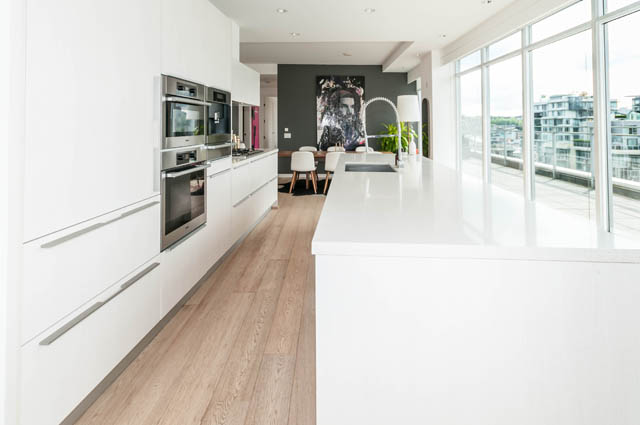 Bright kitchen with white countertops, hardwood floors, and city view. - 1101 - 1661 Ontario Street, Vancouver West Side