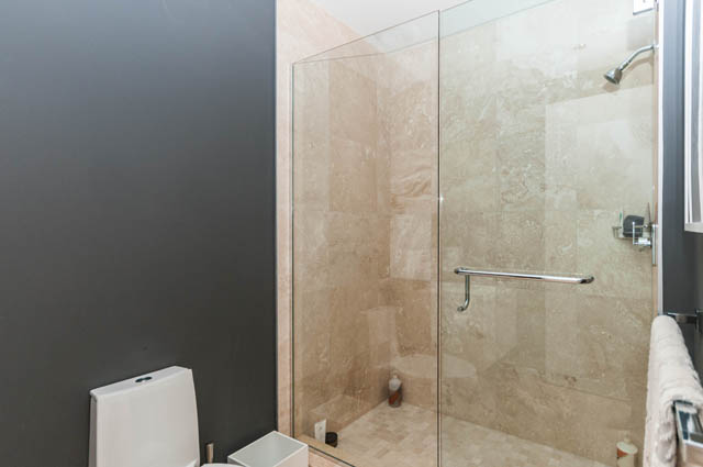 Furnished bathroom with modern glass shower and beige tile walls. - 1101 - 1661 Ontario Street, Vancouver West Side