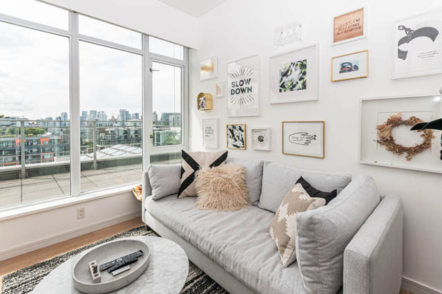 Bright living room with city view, large windows, and a cozy sofa. - 1101 - 1661 Ontario Street, Vancouver West Side
