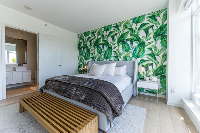 Furnished bedroom with tropical leaf wallpaper and wooden flooring. - 1101 - 1661 Ontario Street, Vancouver West Side