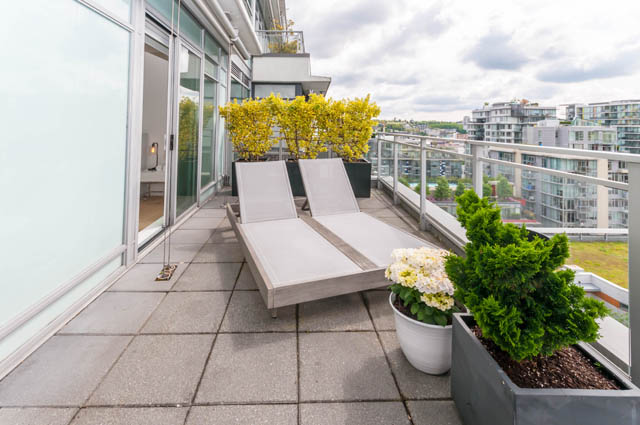 Furnished balcony with lounge chairs, city view, and potted plants. - 1101 - 1661 Ontario Street, Vancouver West Side