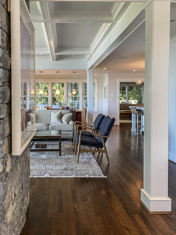 Spacious dining area with hardwood floors and large windows, showcasing natural light and a cozy ambiance. - 235 Maple Lane, West Vancouver