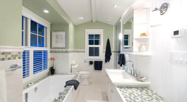 Spacious bathroom with white cabinetry, blue accents, and a large mirror. - 235 Maple Lane, West Vancouver