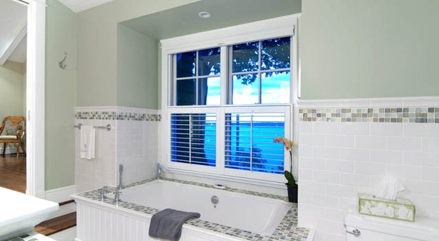 Bright bathroom with white subway tile, large window, and city view. - 235 Maple Lane, West Vancouver