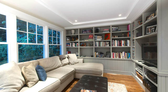 Spacious living room with built-in bookshelves and large windows. - 235 Maple Lane, West Vancouver