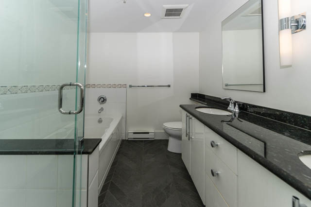 Spacious bathroom with marble countertops and a glass-enclosed shower. - 3205 - 928 Richards St, Vancouver Downtown