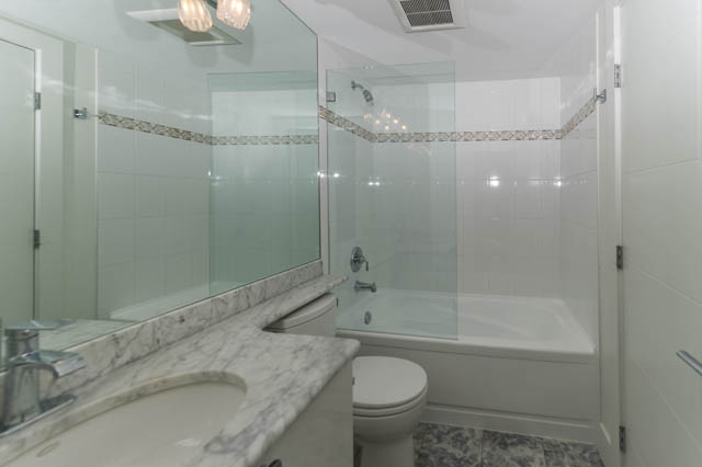 Furnished bathroom with marble countertops and glass shower. - 3205 - 928 Richards St, Vancouver Downtown