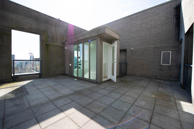 Bright penthouse patio with sliding glass doors and city view. - 3205 - 928 Richards St, Vancouver Downtown