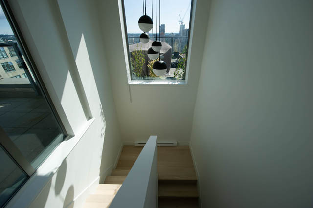 Bright penthouse living room with modern pendant lights and city view. - 3205 - 928 Richards St, Vancouver Downtown