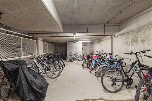 Bike storage area with concrete walls and covered bikes. - 3205 - 928 Richards St, Vancouver Downtown