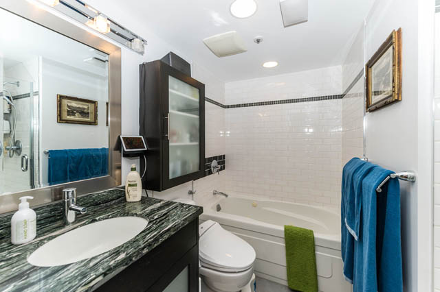 Spacious bathroom with green marble countertop, white subway tile, and a modern black medicine cabinet. - 409 - 1500 Hornby Street, Vancouver Downtown