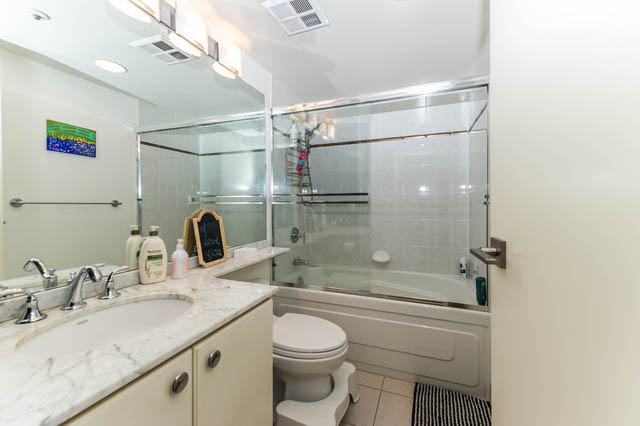 Spacious bathroom with marble countertops and a glass-enclosed shower. - 409 - 1500 Hornby Street, Vancouver Downtown