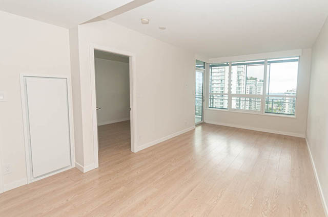 Bright living room with hardwood floors and city view. - 1105 - 125 E 14th St, North Vancouver