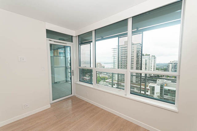 Bright living room with hardwood floors and city view. - 1105 - 125 E 14th St, North Vancouver
