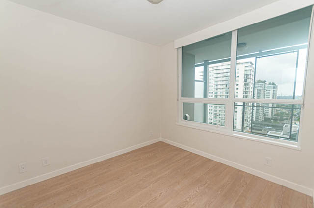 Bright living room with hardwood floors and city view. - 1105 - 125 E 14th St, North Vancouver