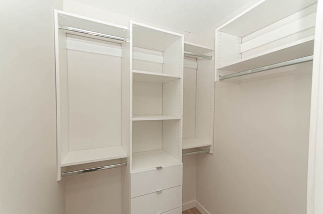 Bright walk-in closet with ample shelving and hanging space. - 1105 - 125 E 14th St, North Vancouver