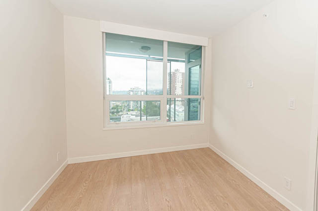 Bright living room with hardwood floors and a city view. - 1105 - 125 E 14th St, North Vancouver