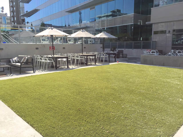 Furnished patio with artificial grass and outdoor furniture. - 1105 - 125 E 14th St, North Vancouver