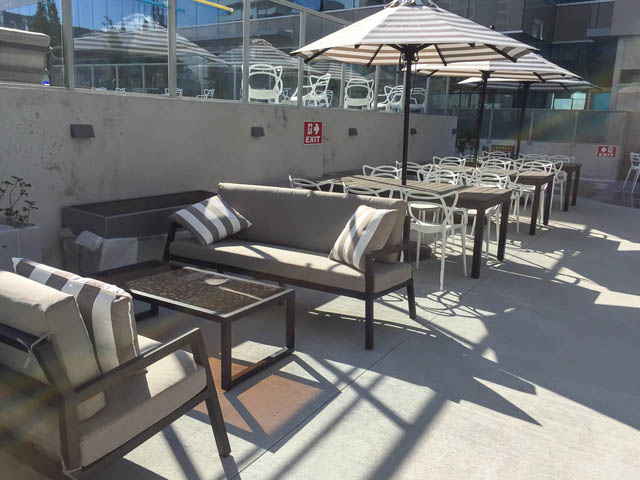 Furnished patio with outdoor seating and umbrellas, perfect for relaxation. - 1105 - 125 E 14th St, North Vancouver