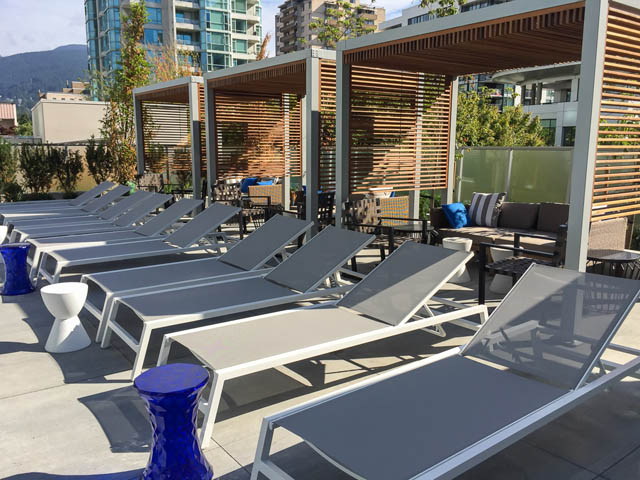 Furnished patio with lounge chairs and city view. - 1105 - 125 E 14th St, North Vancouver
