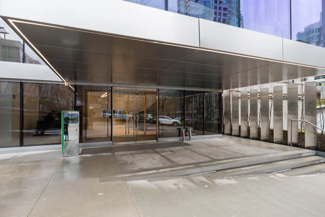Modern entrance with sleek glass and metal accents, leading to a spacious interior. - 1901 - 1480 Howe St, Vancouver Downtown