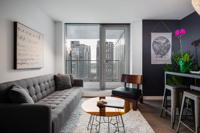 Furnished living room with city view and modern decor. - 1901 - 1480 Howe St, Vancouver Downtown