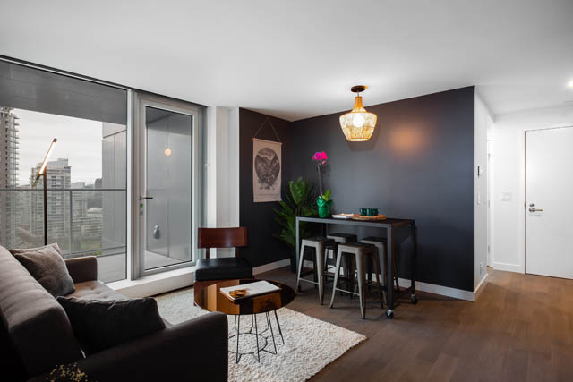 Bright living room with hardwood floors, city view, and modern decor. - 1901 - 1480 Howe St, Vancouver Downtown