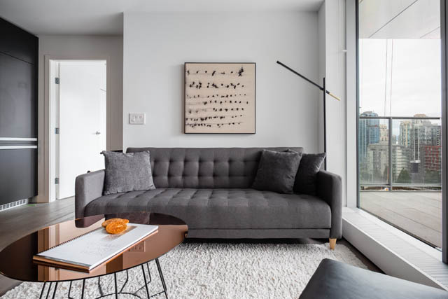 Furnished living room with modern furniture, city view, and sleek decor. - 1901 - 1480 Howe St, Vancouver Downtown