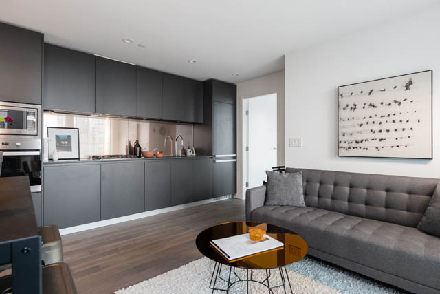 Furnished 1-bedroom condo with modern kitchen, hardwood floors, and a cozy living area. - 1901 - 1480 Howe St, Vancouver Downtown