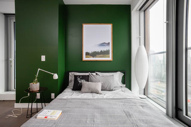 Furnished 1-bedroom with dark green walls, modern decor, and city view. - 1901 - 1480 Howe St, Vancouver Downtown