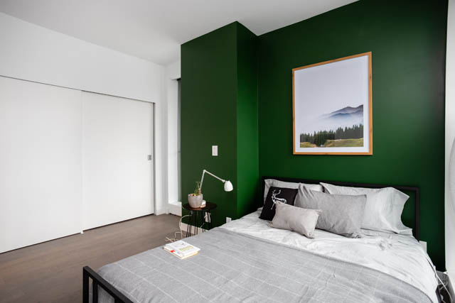 Furnished 1-bedroom with dark green accent wall and modern decor. - 1901 - 1480 Howe St, Vancouver Downtown