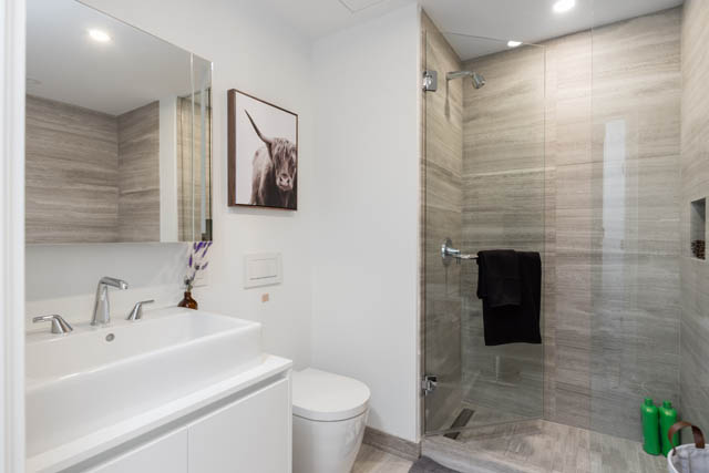 Spacious bathroom with modern fixtures, large mirror, and neutral tones. - 1901 - 1480 Howe St, Vancouver Downtown