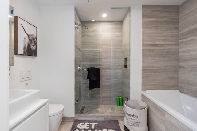 Furnished 1-bedroom condo with modern bathroom, light wood walls, and a sleek sink. - 1901 - 1480 Howe St, Vancouver Downtown