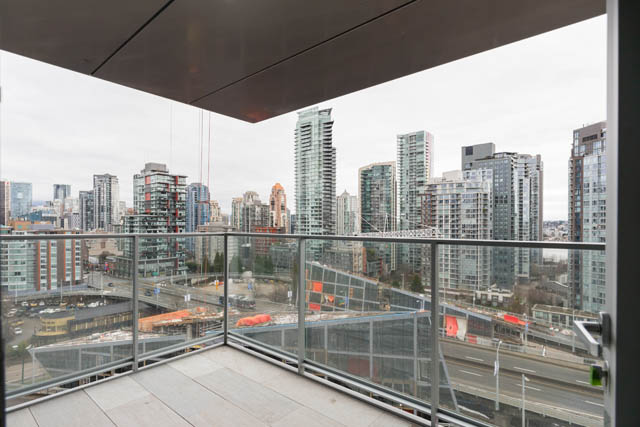 Furnished 1-bedroom balcony with city view and modern architecture. - 1901 - 1480 Howe St, Vancouver Downtown