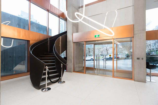 Furnished living room with spiral staircase and modern lighting. - 1901 - 1480 Howe St, Vancouver Downtown