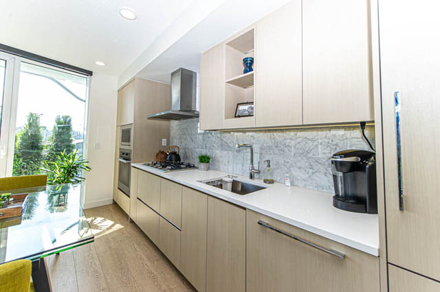 Bright kitchen with marble countertops, hardwood floors, and city view. - 484 - 87 Nelson St, Vancouver Downtown