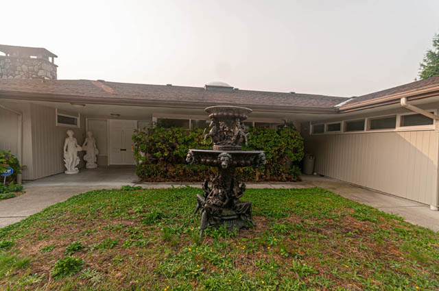 Furnished living room with a decorative fountain and garden view. - 669 Eyremount Drive, West Vancouver