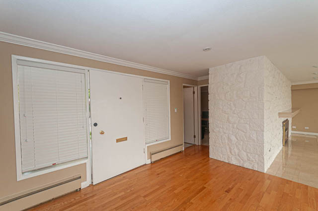 Bright living room with hardwood floors and stone fireplace. - 669 Eyremount Drive, West Vancouver