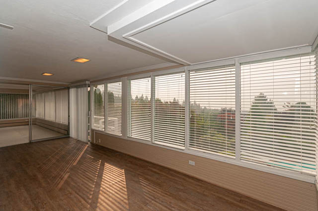 Spacious living room with large windows, hardwood floors, and city view. - 669 Eyremount Drive, West Vancouver