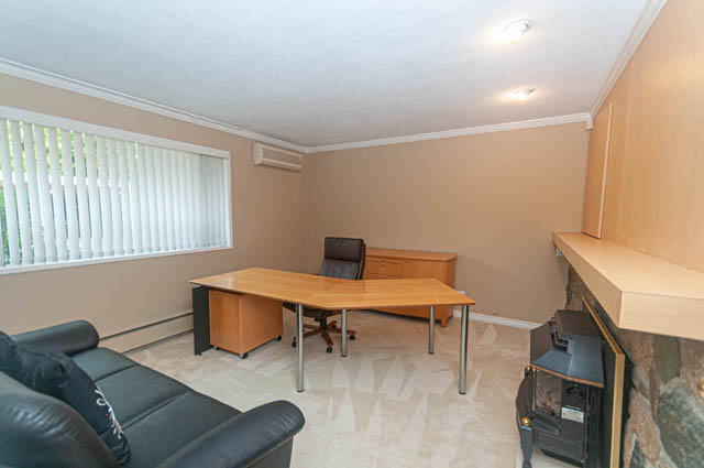 Furnished living room with wooden furniture and large window. - 669 Eyremount Drive, West Vancouver