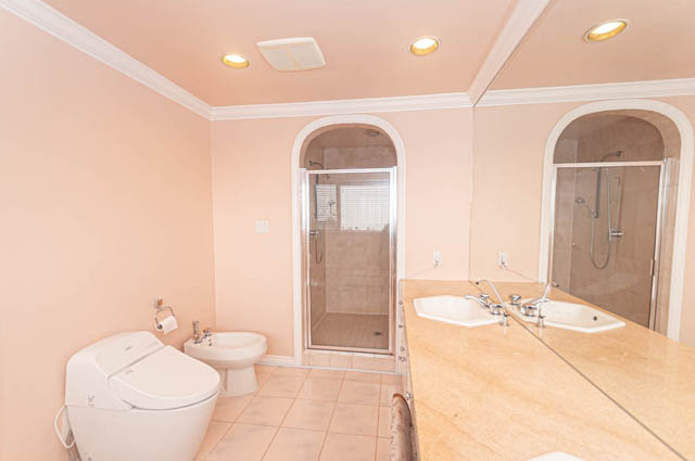 Spacious bathroom with beige tiles, large mirror, and modern fixtures. - 669 Eyremount Drive, West Vancouver