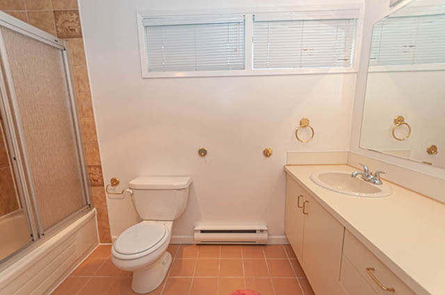 Bathroom with white sink, gold fixtures, and large mirror. - 669 Eyremount Drive, West Vancouver