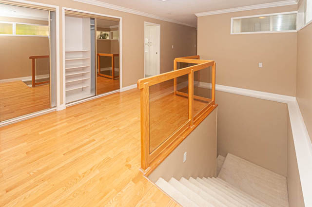 Bright entryway with hardwood floors and a glass railing leading to the stairs. - 669 Eyremount Drive, West Vancouver
