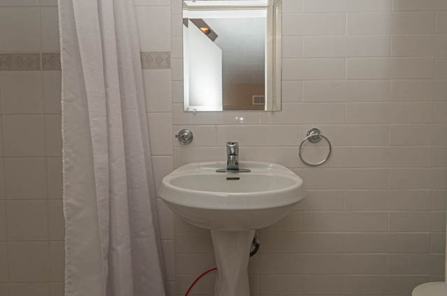 Bright bathroom with white tiles and a modern sink setup. - 669 Eyremount Drive, West Vancouver