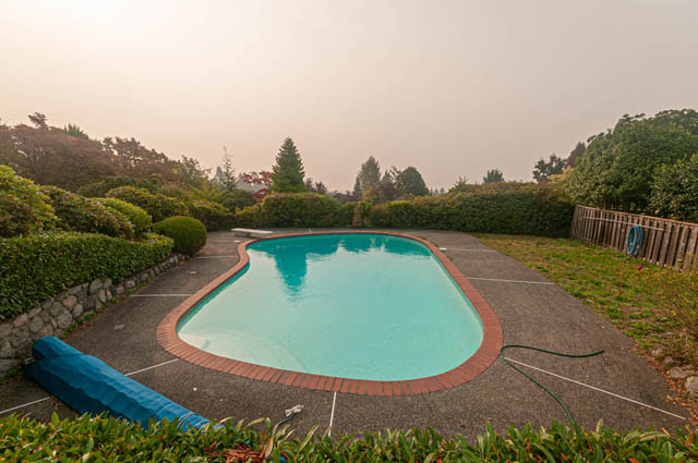 Spacious backyard with a large, inviting pool surrounded by lush greenery. - 669 Eyremount Drive, West Vancouver