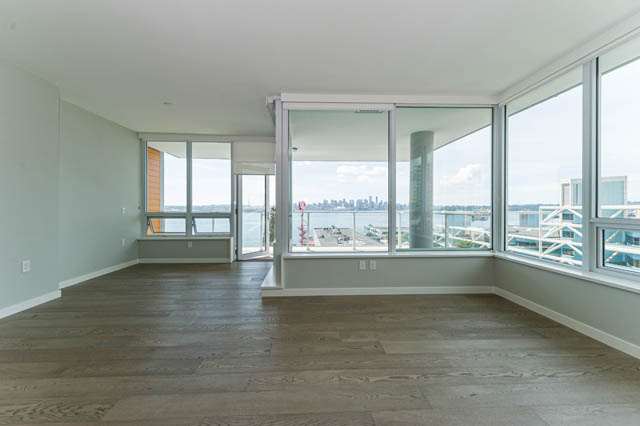 Bright living room with hardwood floors and city view. - 802 - 118 Carrie Cates Court, North Vancouver