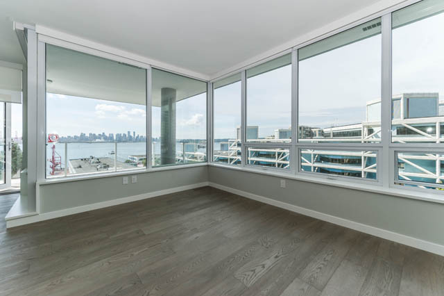 Bright living room with hardwood floors and stunning city view. - 802 - 118 Carrie Cates Court, North Vancouver