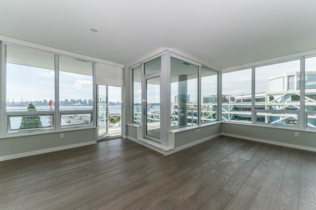 Bright living room with hardwood floors and expansive city view. - 802 - 118 Carrie Cates Court, North Vancouver