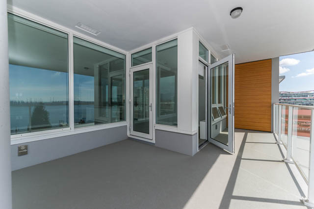 Spacious balcony with sliding glass doors, city view, and modern furnishings. - 802 - 118 Carrie Cates Court, North Vancouver